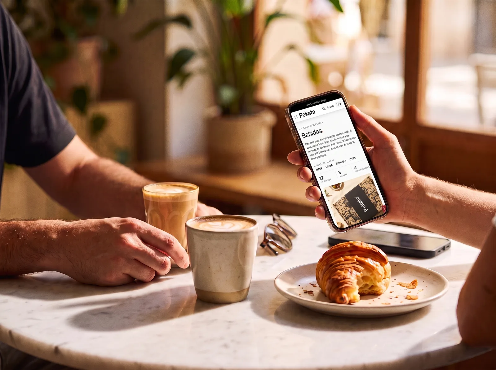 Two people having coffee while looking at the Pekata portal on a phone